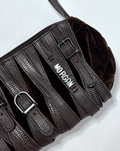 Belt buckles all over baguette bag